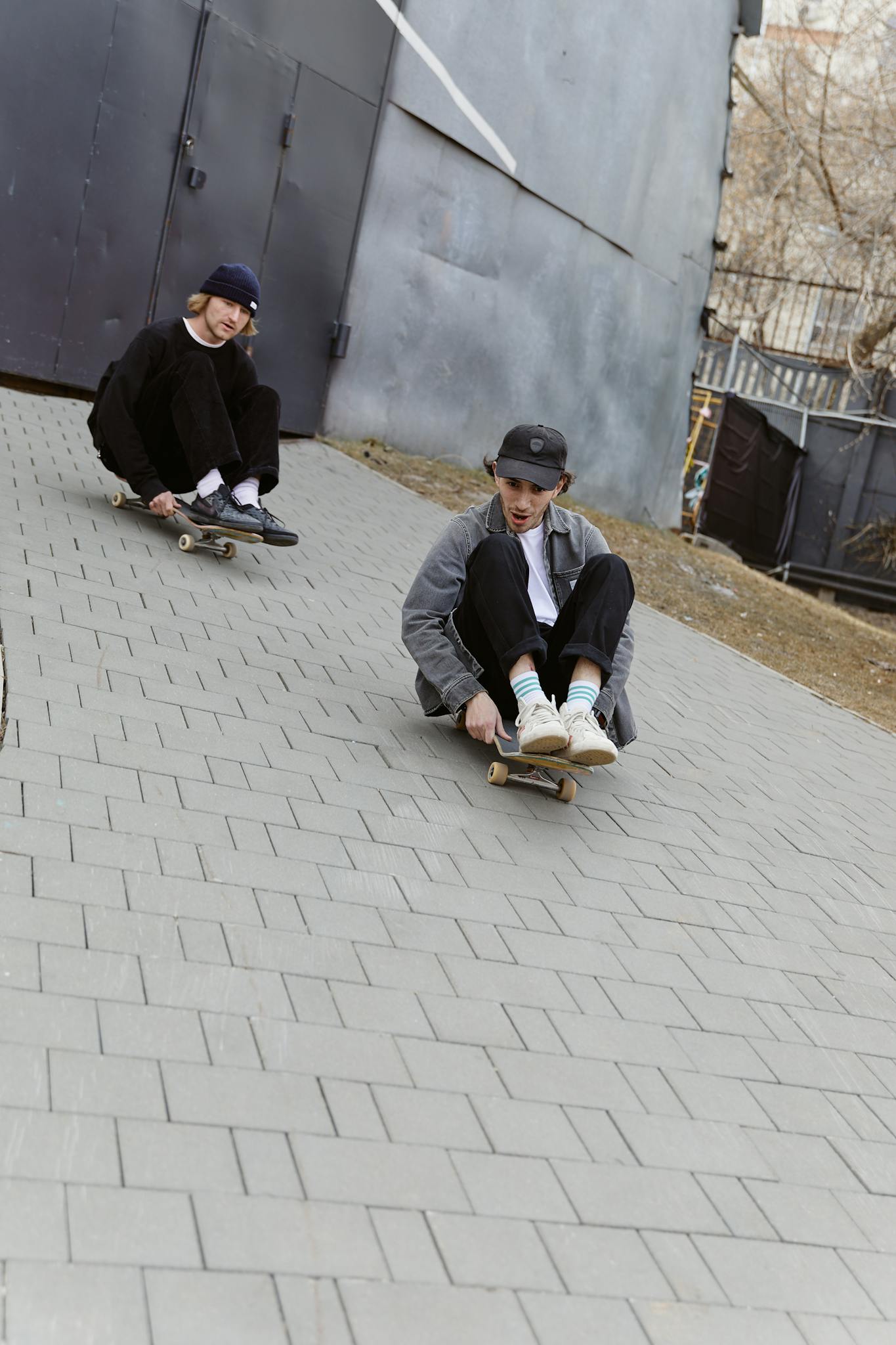 Two friends having fun skateboarding outdoors, showcasing youthful energy and friendship.